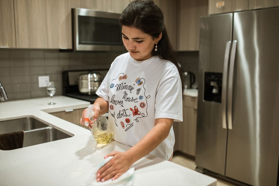 Maid service professional wiping a kitchen counter